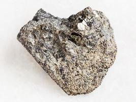 rough peridotite stone with phlogopite on white photo