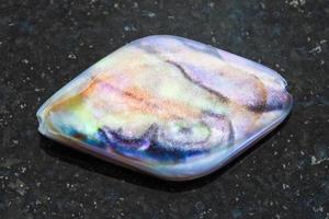 bead from Abalone haliotis shell on dark photo