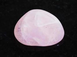 polished Rose Quartz gem stone on dark photo
