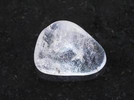 polished Rock-crystal gem stone on dark photo