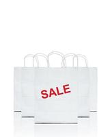 white shopping bags with the word sale on white photo