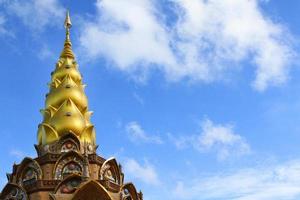 Golden pagoda peak of Wat Phra That Pha Son Kaew temple with blue sky and white clouds background and copy space on right. Landmark North of Thailand and Exterior design ancient building. Religion. photo