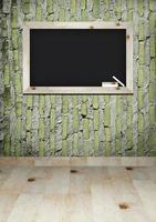 empty blackboard with wooden frame and chalks on wall room photo