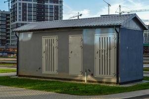 electrical house with power lines. light box booth. place of work of an electrician. concrete house with insulation and air conditioning for electricity shields photo