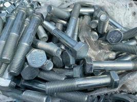 Background, texture of many metal small iron bolts and stainless steel fasteners, fittings and mitiz photo