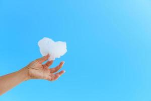 White cloud in hand against the blue sky. photo