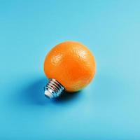 Orange light bulb on a blue background. The concept of fruit ideas photo