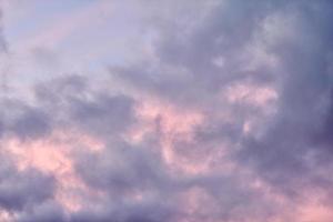 Fluffy cumulus purple and pink clouds, cloudscape photo