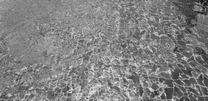 Art of swimming pool background in black and white. Abstract wave on water and reflection wallpaper in monochrome style. photo