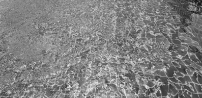 Art of swimming pool background in black and white. Abstract wave on water and reflection wallpaper in monochrome style. photo