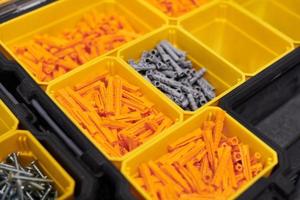 Storage case with screws, nuts, bolts, nails and other small tools for handyman, close up photo