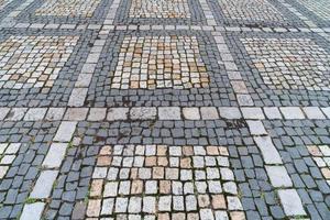 Tiles texture. Pattern of ancient german cobblestone in city downtown. Little granite paving stones. Antique gray pavements. photo