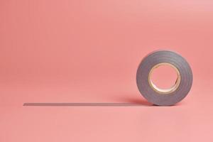 Electrical tape roll, copy space. Minor repairs in house concept. Minimal pink background. photo