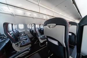 Airplane seats and windows. Economy class comfortable seats without passengers. New low-cost carrier airline photo