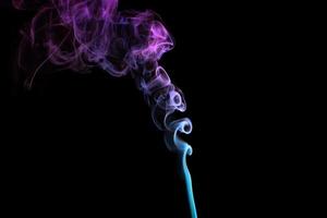 Multicolored smoke for aromatherapy relaxation on black background, beautiful swirled puffs of smoke photo