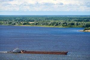 Barge on river sailing to port for cargo. Transport for transportation of crushed stone and sand photo