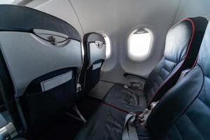 Airplane seats and windows. Economy class comfortable seats without passengers. New low-cost carrier airline photo