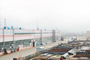 Industrial landscape. Panoramic view of the technological pipes. Rusty pipes, blue rubies, production communications. Repair buildings in production. Against the background of a misty sky photo