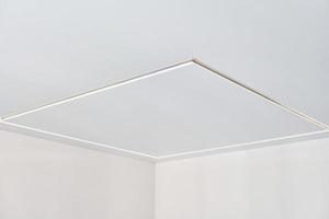 Suspended ceiling with LED strip lamp in empty room, repair photo