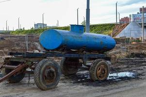 blue oval water car. water supply when it is turned off in the city center. free water for people. spilling water into buckets and bottles. mobile water station photo