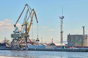 Harbor cranes, container ship terminal, cargo container yard photo