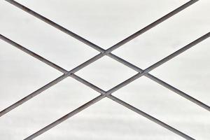 Metal fence with rhombus ornament on grey background photo