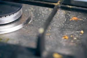 Dirty stove top with oil splatters, fat stains and food leftovers photo