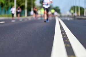 Marathon runners on city road. photo