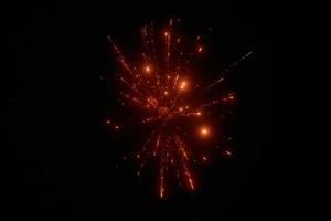 Red night fireworks bright sparkles and shiny festival explosion, glittering motion of sky fire photo