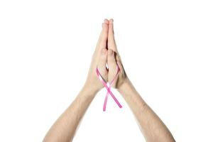 Pink awareness ribbon in hand photo