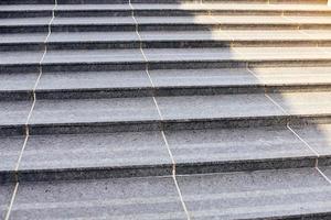 Grey stone steps in modern style, large staircase with stone-like grey texture, wide granite ladder photo