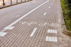 Two way cycle path, marking bike path on sidewalk, white painted bicycle sign on road, cycle symbol photo