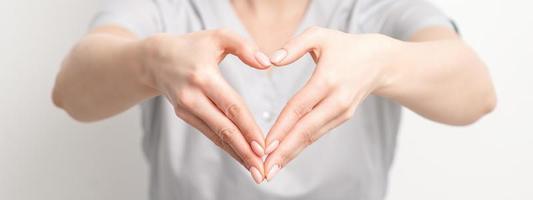 Female hands of doctor making heart shape photo