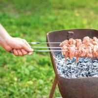 Hands of man prepares barbecue meat photo