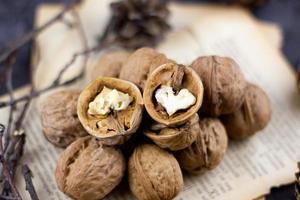 a group of walnuts on a dark background, a concept for the winter season. photo