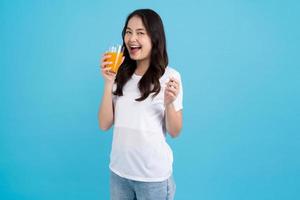 Beautiful woman drinking orange from a glass photo