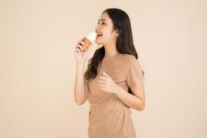 Happy young woman eating ice cream photo