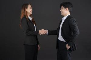 The two young businessmen shook hands to congratulate. photo