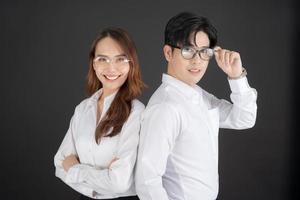 Two young businessmen standing with their arms crossed. photo