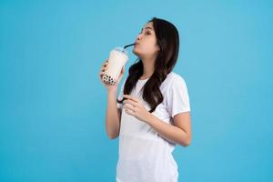 Asian girl holding a cup of pearl milk tea With a smile, fun and happiness photo