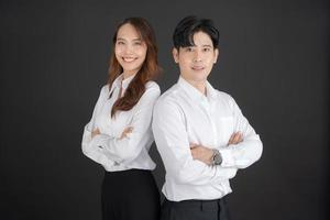 Two young businessmen standing with their arms crossed. photo