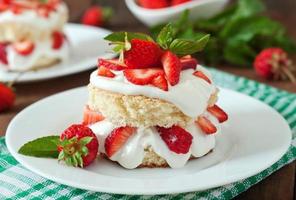 Sponge cake with cream and strawberries photo