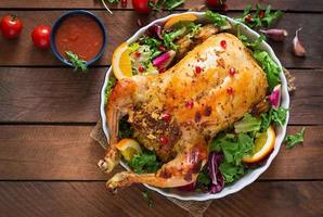 Baked chicken stuffed with rice for Christmas dinner on a festive table photo