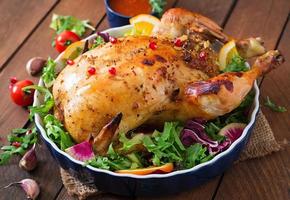 Baked chicken stuffed with rice for Christmas dinner on a festive table photo