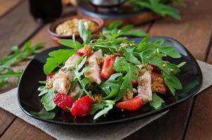 Chicken salad with arugula and strawberries photo