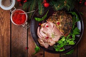 Christmas baked ham and red caviar, served on the old wooden table. Flat lay. Top view photo