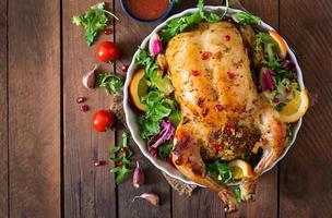 Baked chicken stuffed with rice for Christmas dinner on a festive table photo