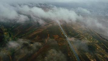 car moves in fog top view photo