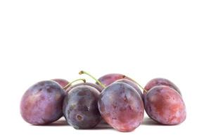 Pair of purple Plums with leaf isolated on white background. photo