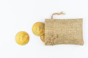 un primer plano de bitcoins con una bolsa sobre un fondo blanco foto